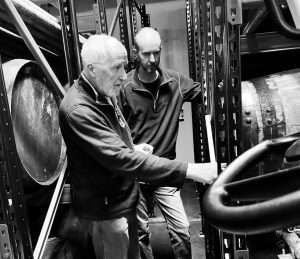 Peter and Matt Bowyer inspecting whisky barrels