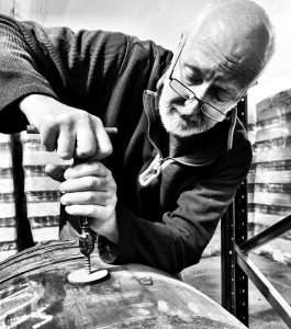 Peter Bowyer examining whisky cask at Fort Glen warehouse