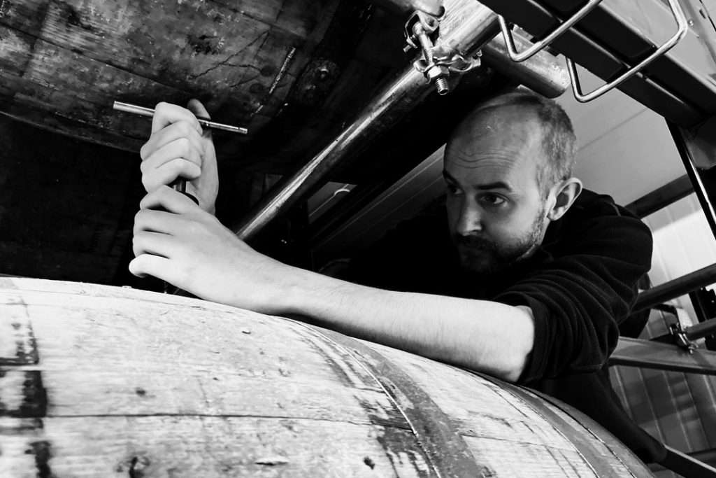 Matt Bowyer examining whisky cask at Fort Glen warehouse